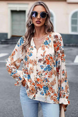 a woman wearing a floral blouse and jeans