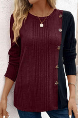 a woman wearing a burgundy sweater and jeans