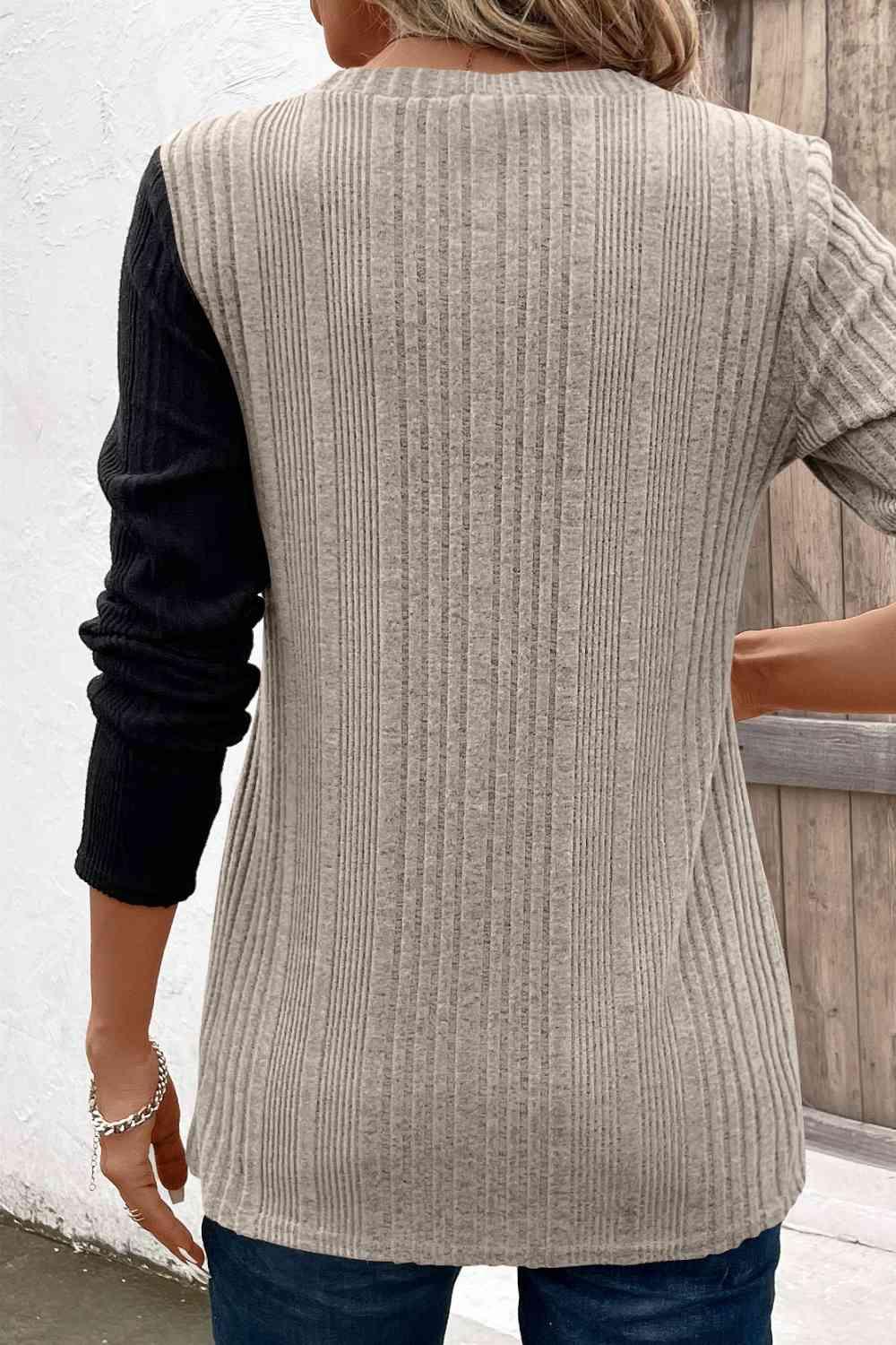a woman wearing a sweater and jeans