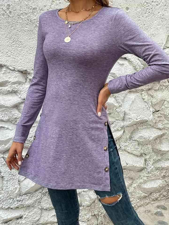 a woman wearing a purple shirt and jeans