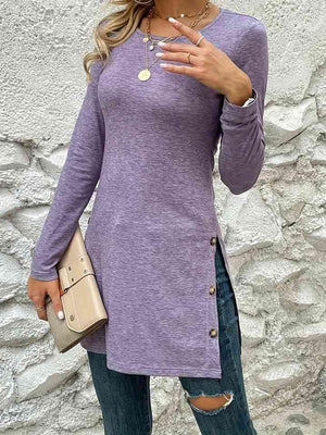 a woman wearing a purple shirt and ripped jeans