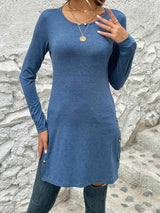 a woman in a blue shirt is posing for a picture