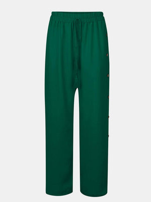 a green pants with buttons on the side