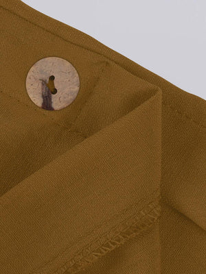 a close up of a button on a brown shirt