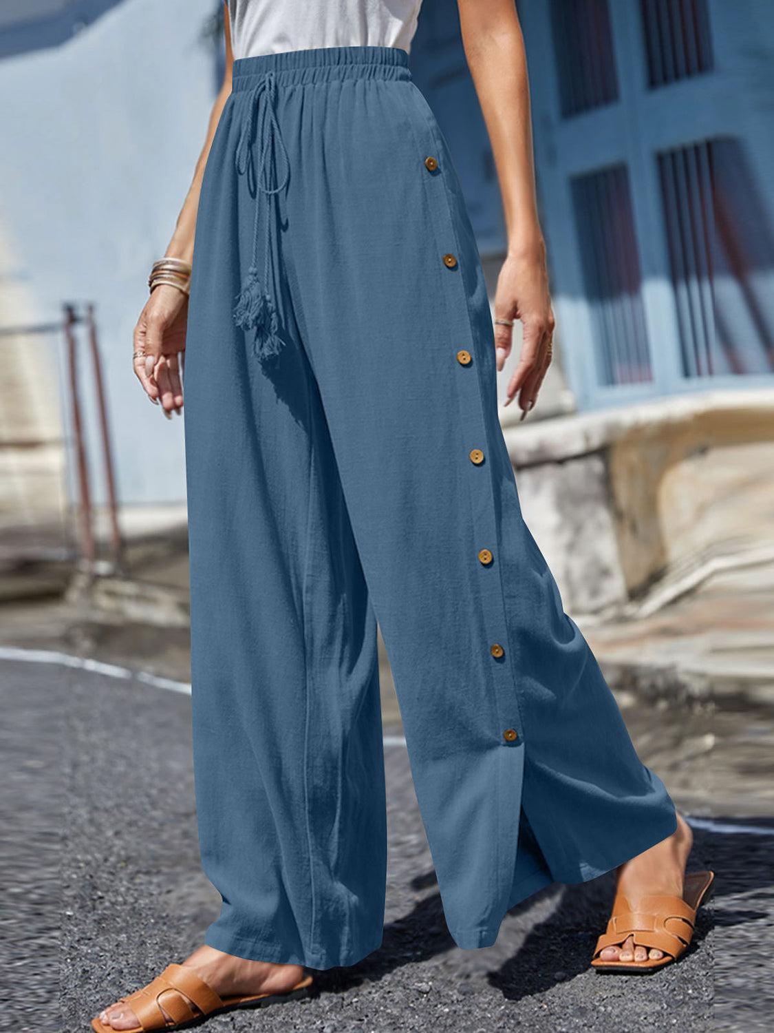 a woman in a white shirt and blue pants