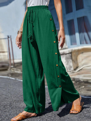 a woman in a white shirt and green pants