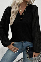 a woman wearing a black sweater and jeans