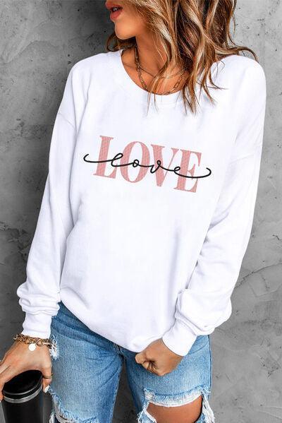 a woman wearing a white sweatshirt with the word love printed on it