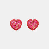 a pair of red heart shaped earrings on a white background