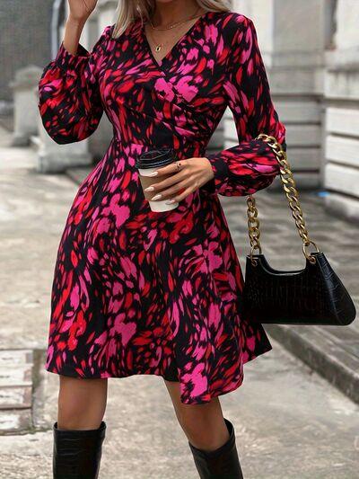 a woman in a pink and black dress holding a cup of coffee