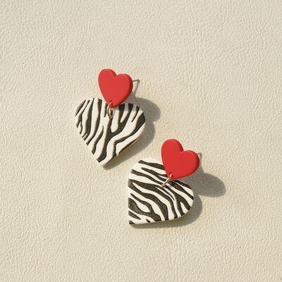 a pair of zebra print heart shaped earrings