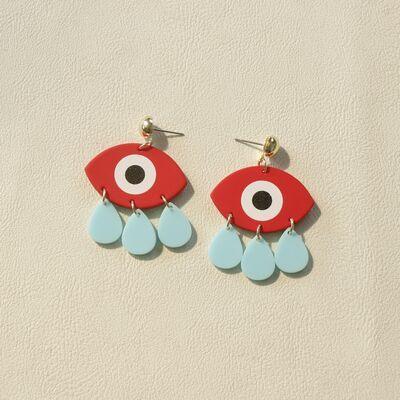 a pair of red and blue earrings with an evil eye