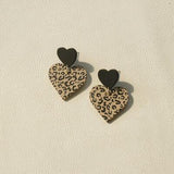 a pair of leopard print heart shaped earrings