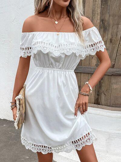 a woman wearing a white off the shoulder dress