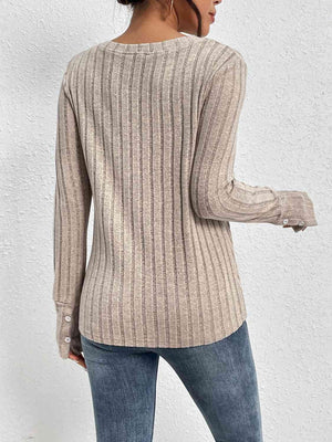 a woman is wearing a sweater and jeans