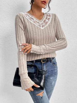 a woman wearing ripped jeans and a sweater