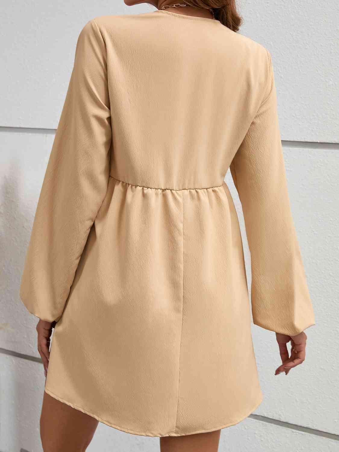 the back of a woman wearing a tan coat