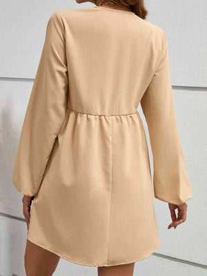 the back of a woman wearing a tan coat