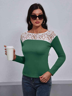 a woman in a green top holding a cup of coffee