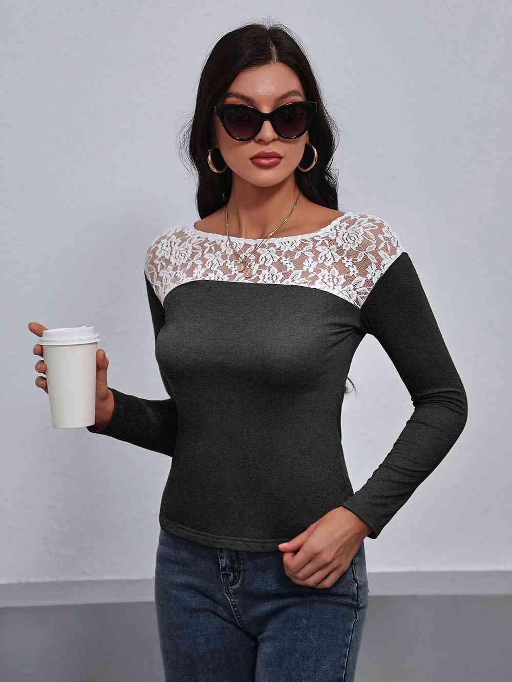 a woman in a black and white top holding a cup of coffee