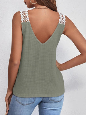a woman wearing a green tank top with a lace back