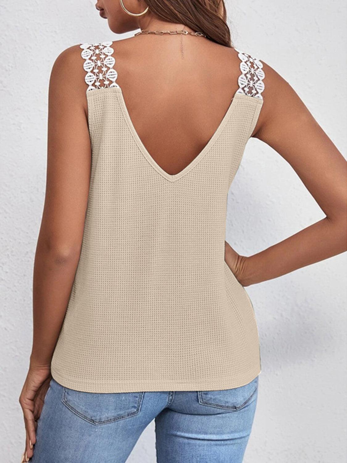 a woman wearing a tan tank top with a lace back