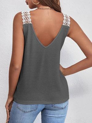 a woman wearing a tank top with a crochet back