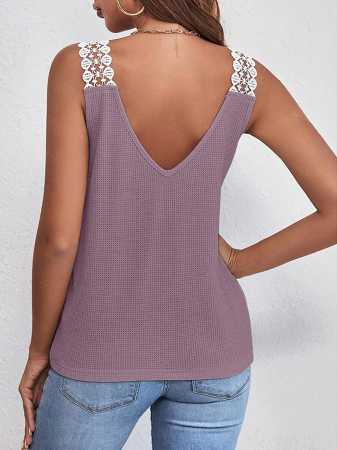 a woman wearing a purple tank top with a lace back