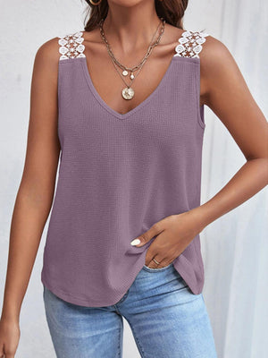 a woman wearing a purple tank top with a lace detail