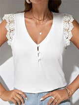 a woman wearing a white top with lace sleeves