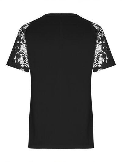 a black t - shirt with white lace sleeves