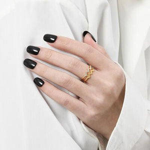 a woman with black nails and a ring on her finger