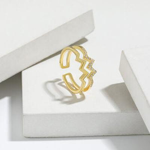 a gold ring sitting on top of a white box