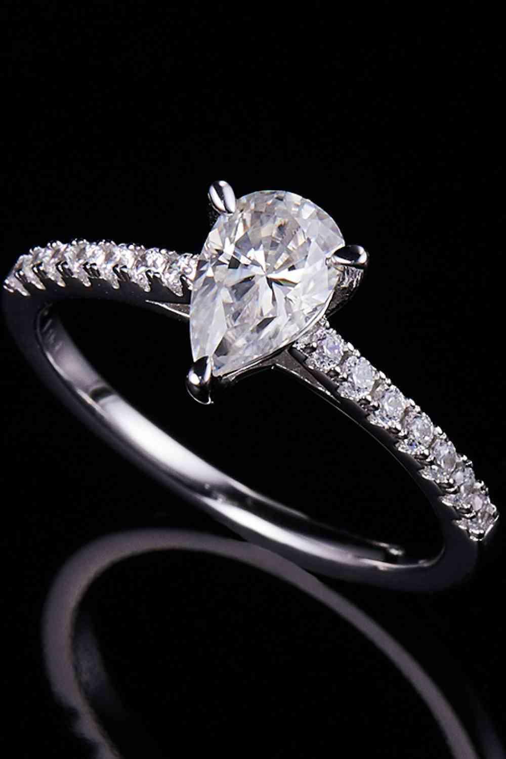 a white gold ring with a pear shaped diamond