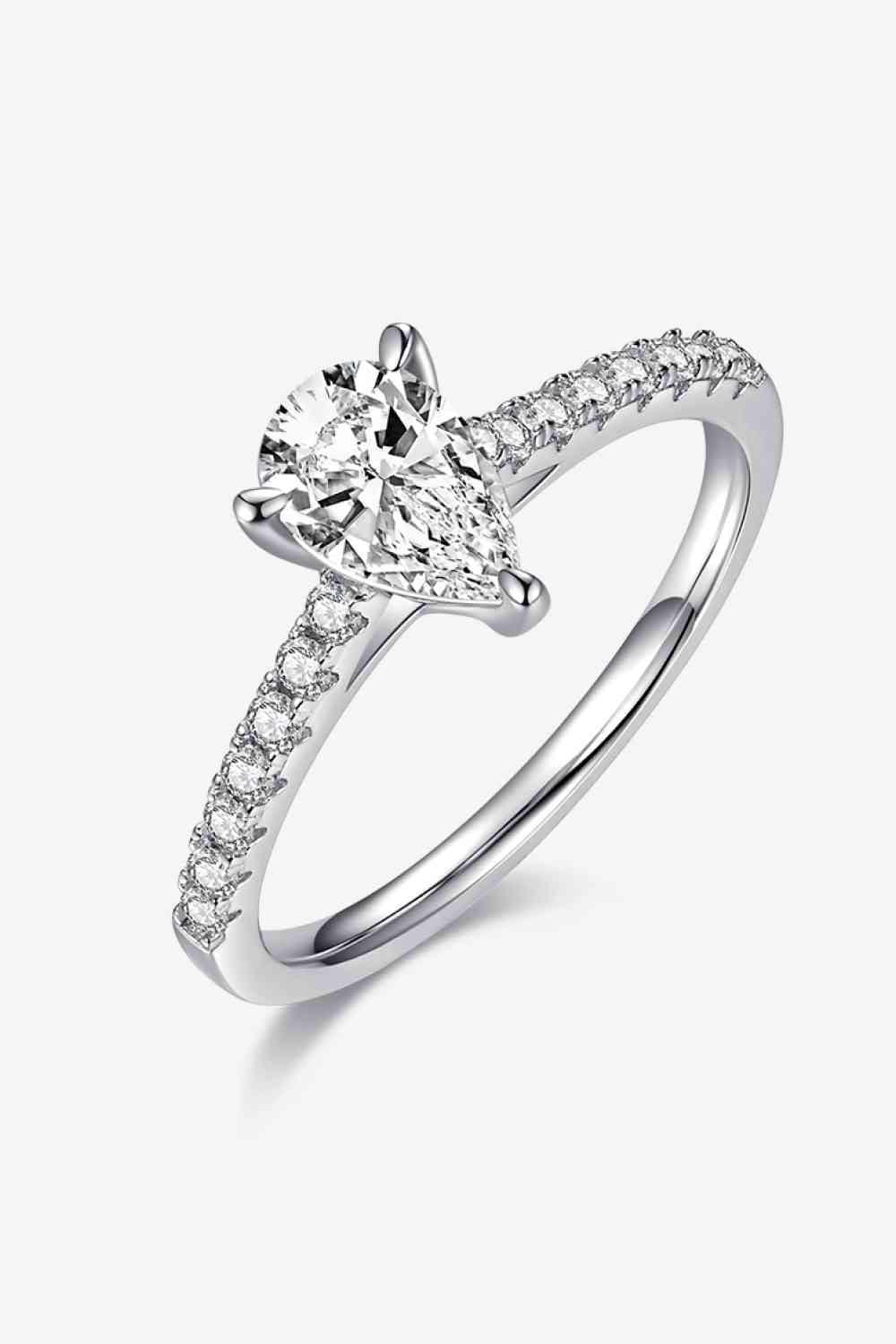 a white gold ring with a pear shaped diamond