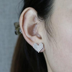 a close up of a person wearing a pair of earrings