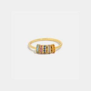 a gold ring with multicolored stones