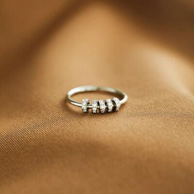 a diamond ring sitting on top of a brown cloth