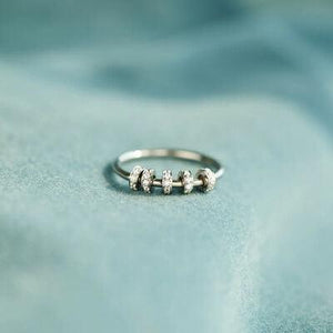 a close up of a ring on a blue cloth