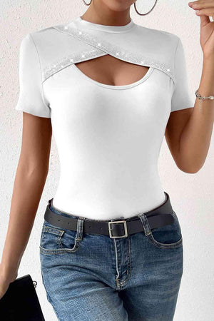 a woman wearing a white top and jeans