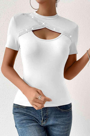 a woman wearing a white top with a cut out shoulder