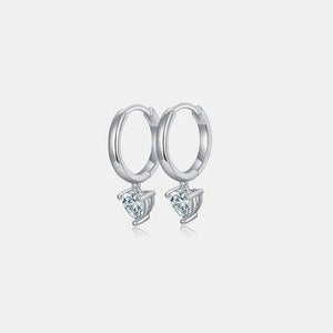 a pair of earrings with a heart shaped diamond