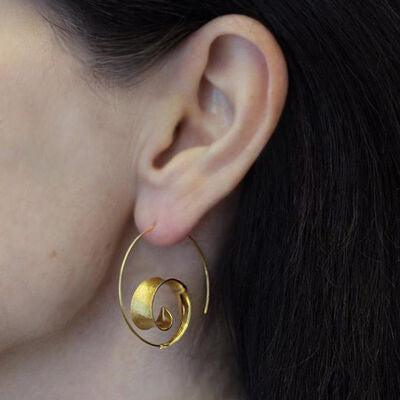 a close up of a person wearing a pair of earrings