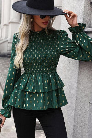 a woman wearing a black hat and green blouse