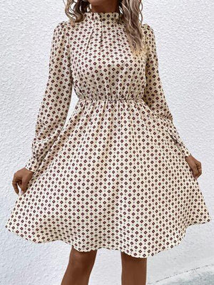 a woman wearing a white and brown polka dot dress