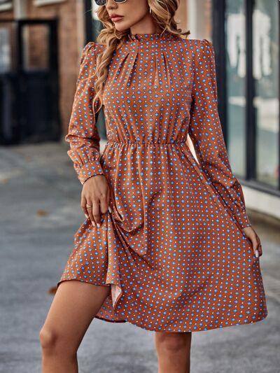 a woman wearing a brown polka dot dress