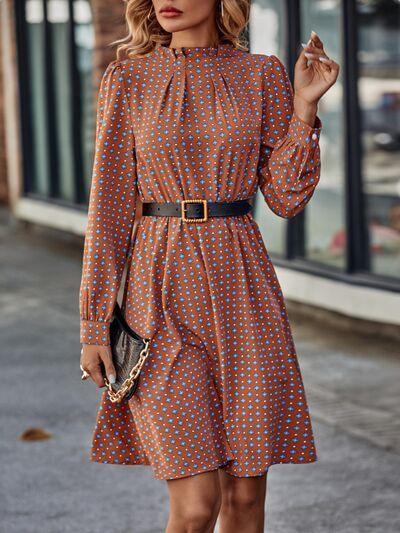 a woman in a polka dot dress is walking down the street