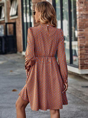 a woman in an orange polka dot dress