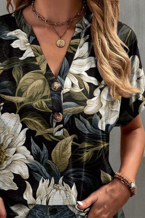 a woman wearing a black and white floral shirt