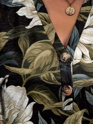 a close up of a person wearing a shirt with flowers on it